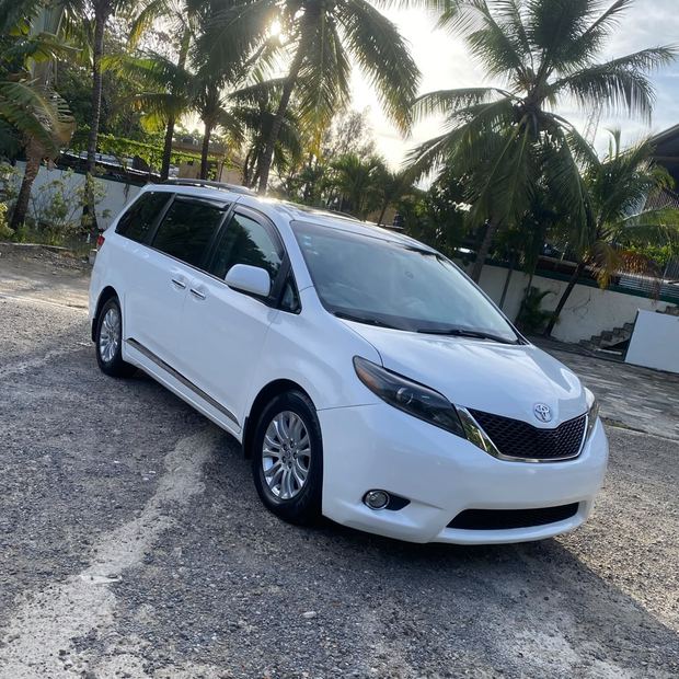 Toyota Sienna parked under palm trees in Cabarete